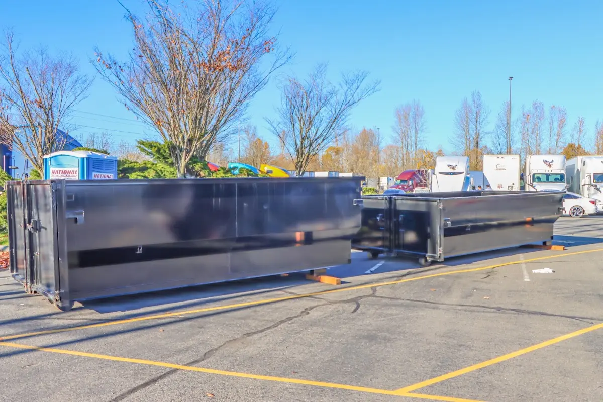 Professional dumpster rental service with roll-off container on residential driveway in Oak Creek